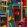 Piazza Degli Arlecchini Wallpaper by MINDTHEGAP Blue/Purple