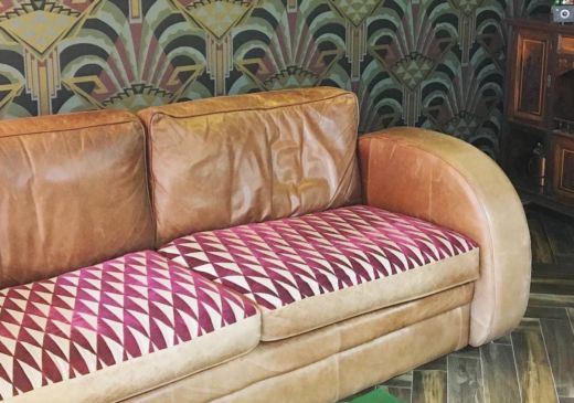 Upholstered leather sofa with Harlequin Irradiant fabric in berry colour